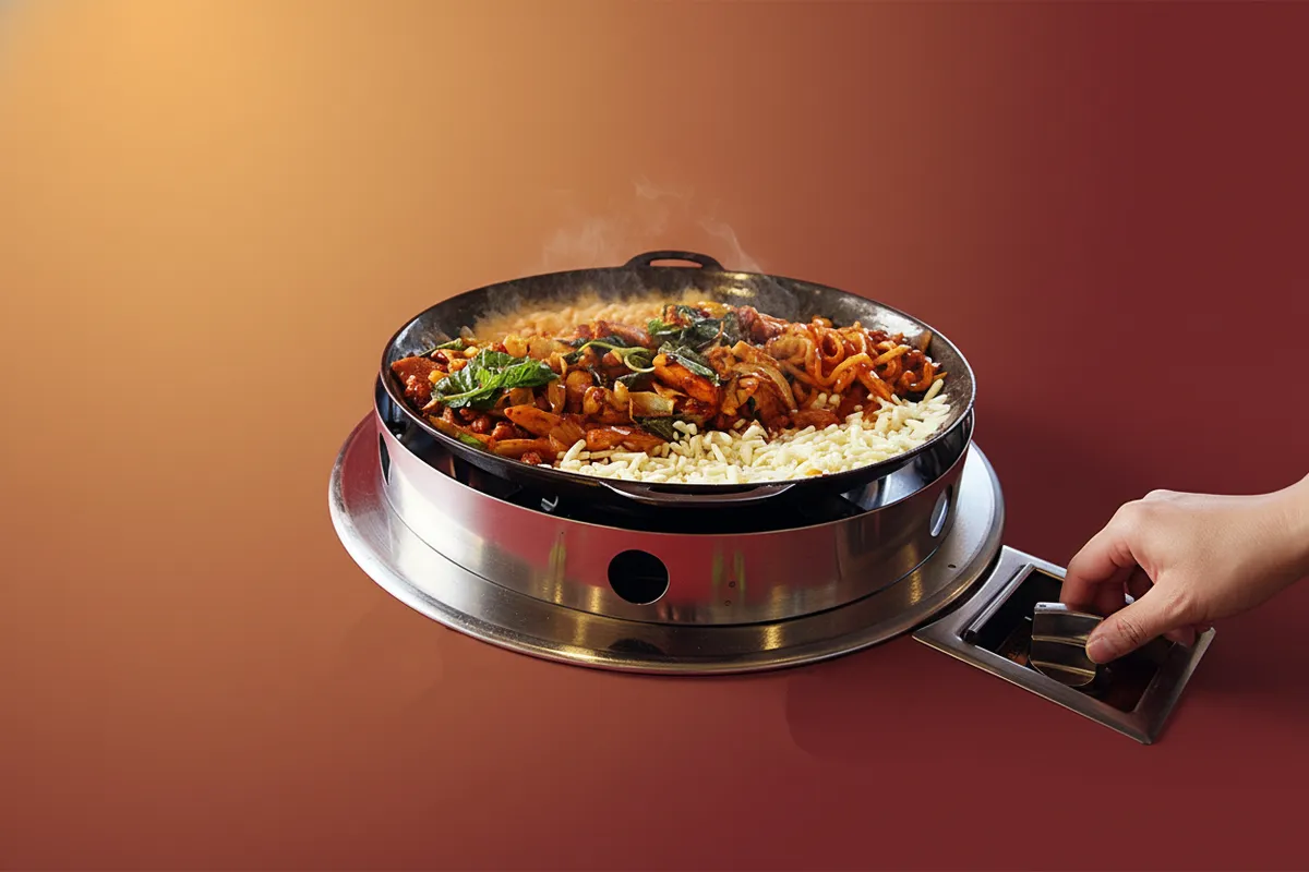 While adjusting the heat with the gas stove dial