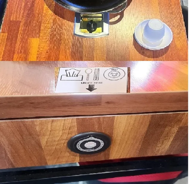 Call bell located on the side of the table - below the wooden drawer