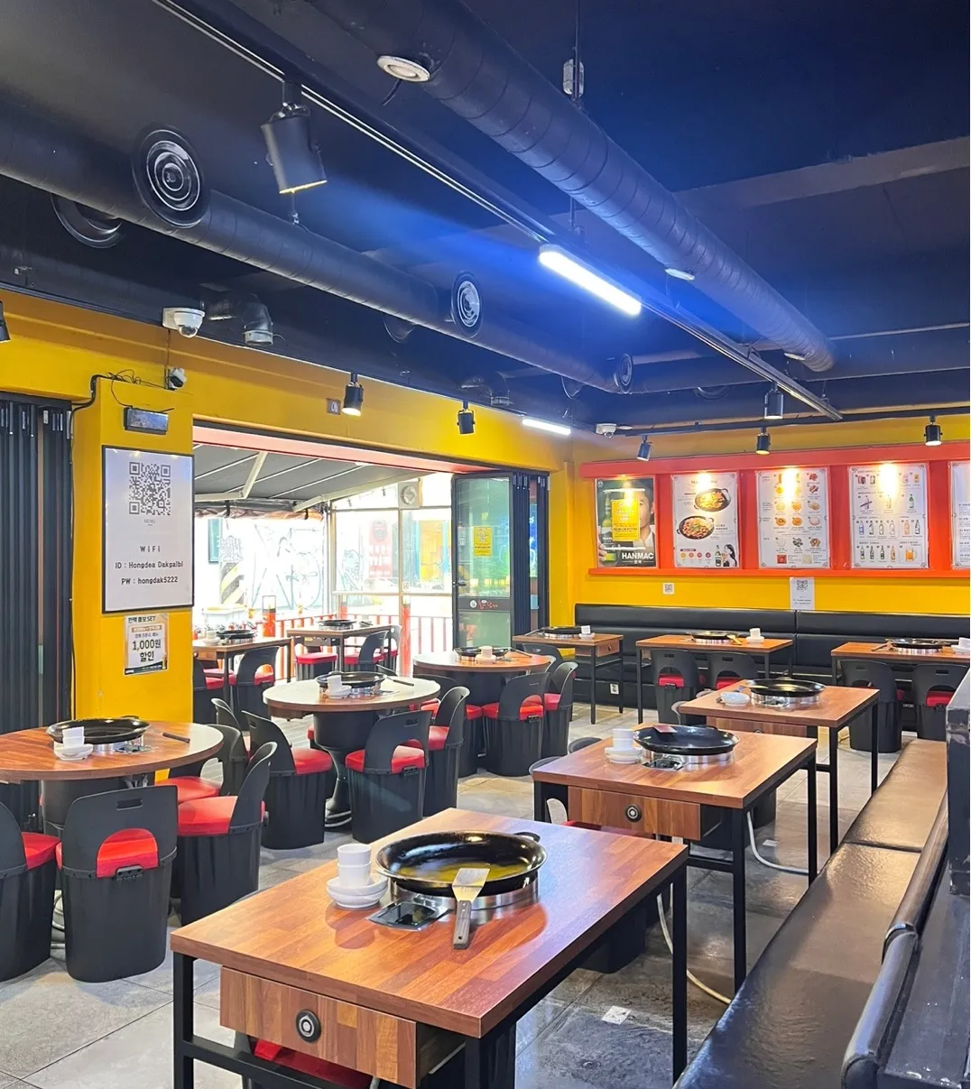 Spacious interior with multiple dining tables and modern Korean restaurant design